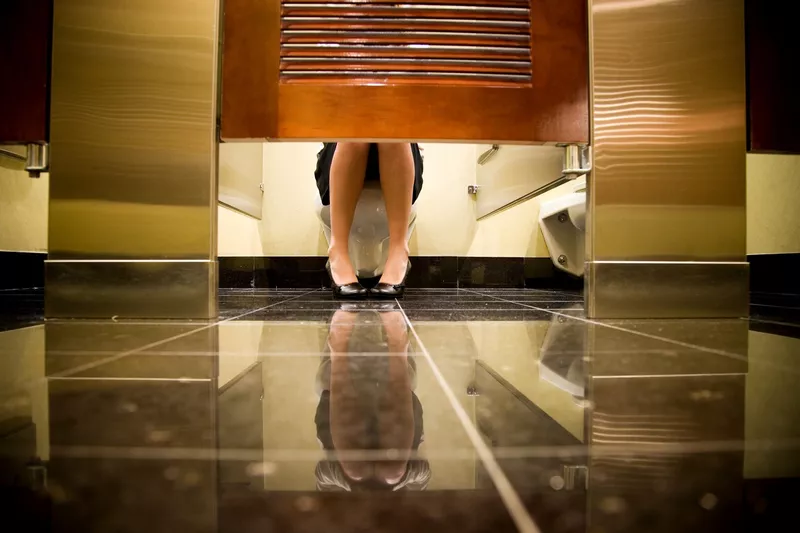 Woman sitting on toilet