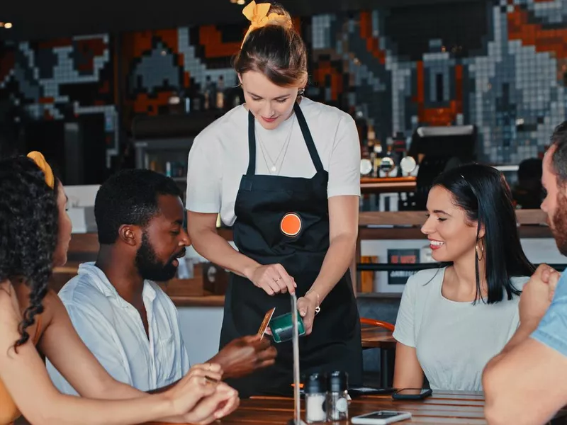 Friends paying the bill with a credit card at a diner