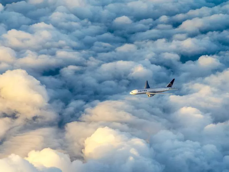 United Airlines aircraft flying over clouds