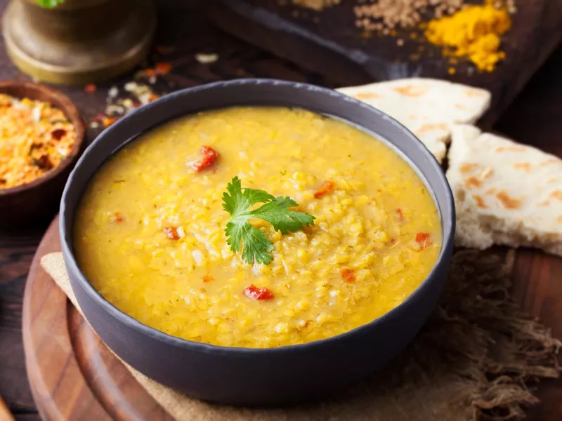 Red lentil Indian soup with flat bread. Masoor dal.