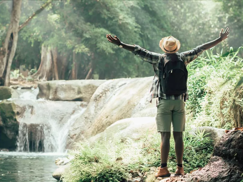 Man enjoys the beauty of a waterfall