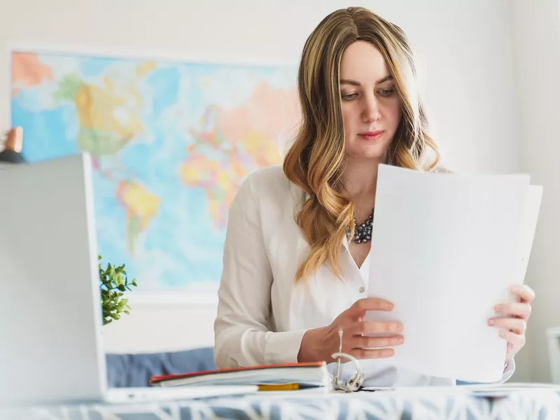 Travel agent working with documents at office