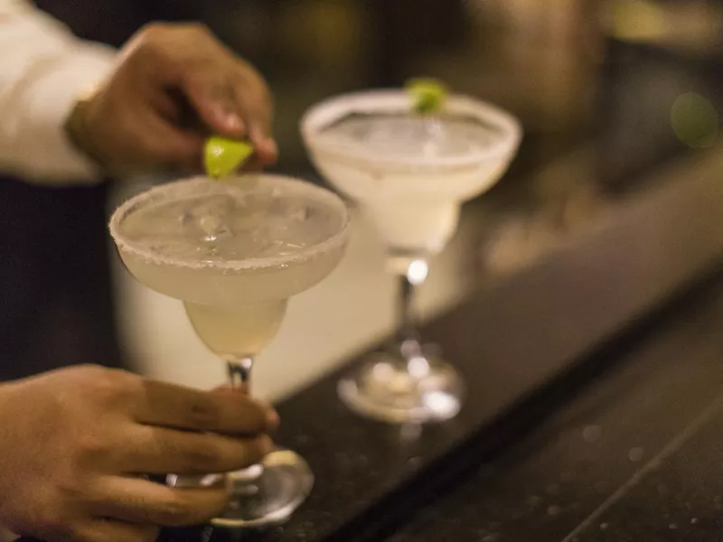 Bartender serving margaritas