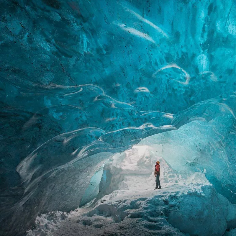 Person standing next to ice wall