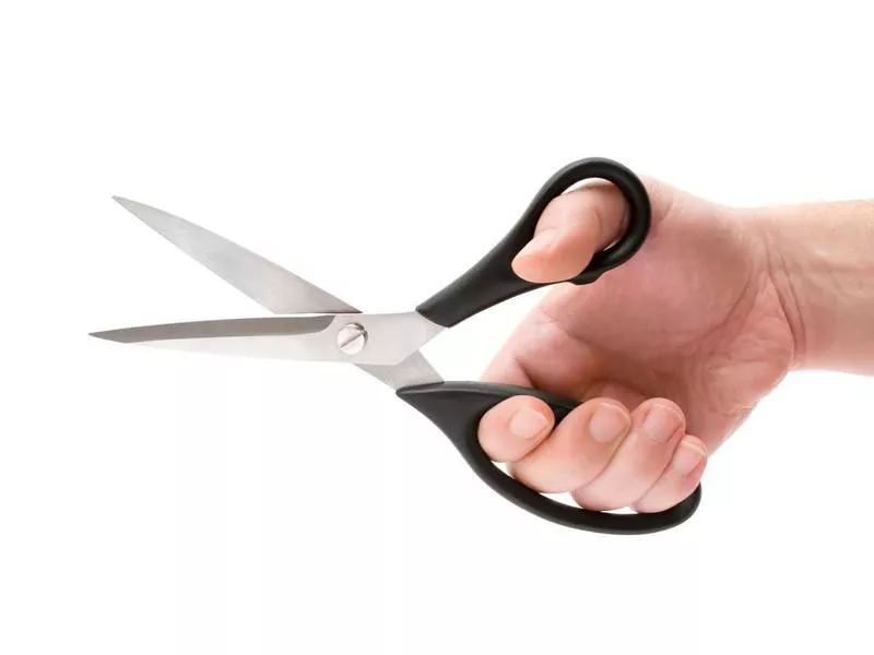 Hand holding scissors