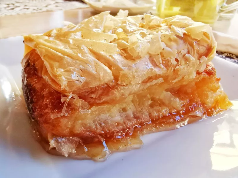 Traditional Greek desserts galaktoboureko on the table