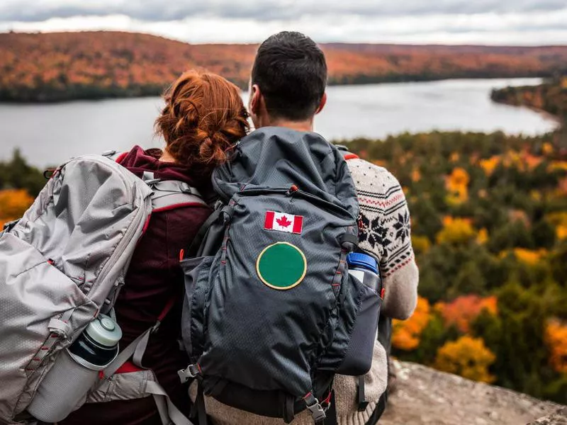 Couple hiking in mountain and relaxing looking at view