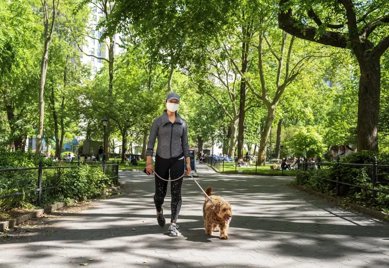 Young woman walking her dog