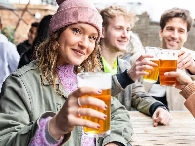 Friends drinking and toasting with beer at pub