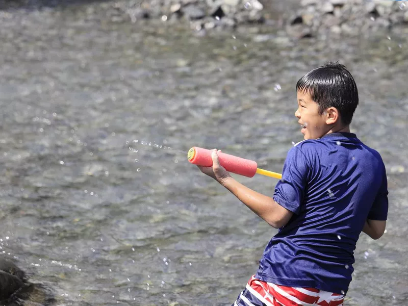 Boy playing with water gun