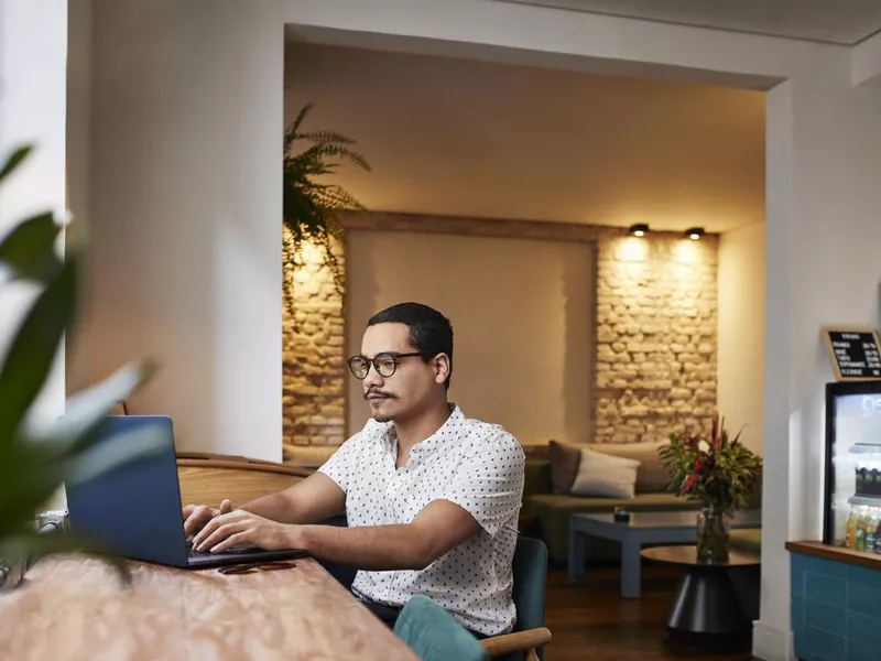 Brazilian man working from a cafe