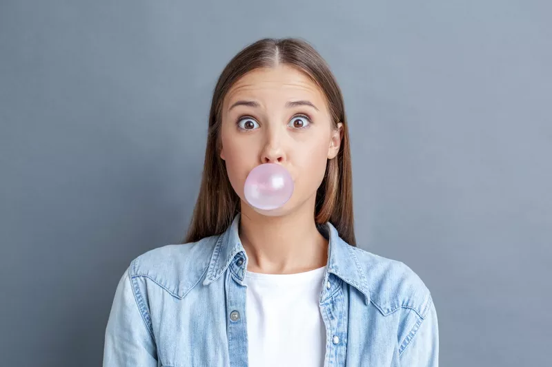 Young woman blowing a bubble