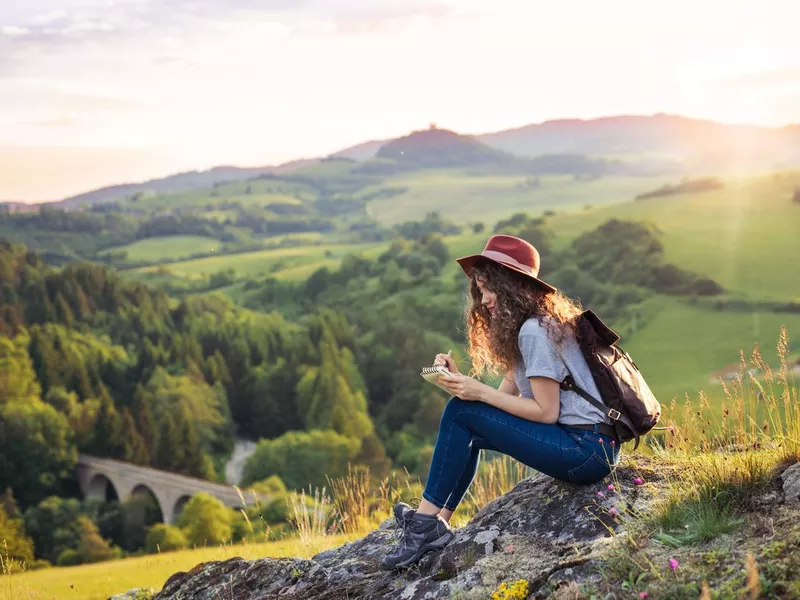 Traveler writing in a journal