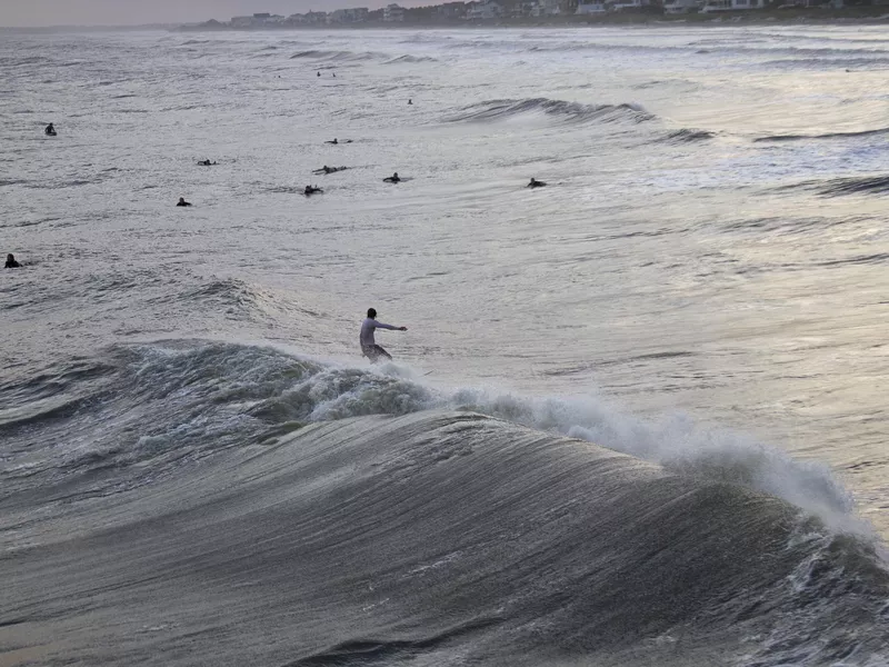 Surfers Catching Hurricane Sandy Waves at Folly Beach