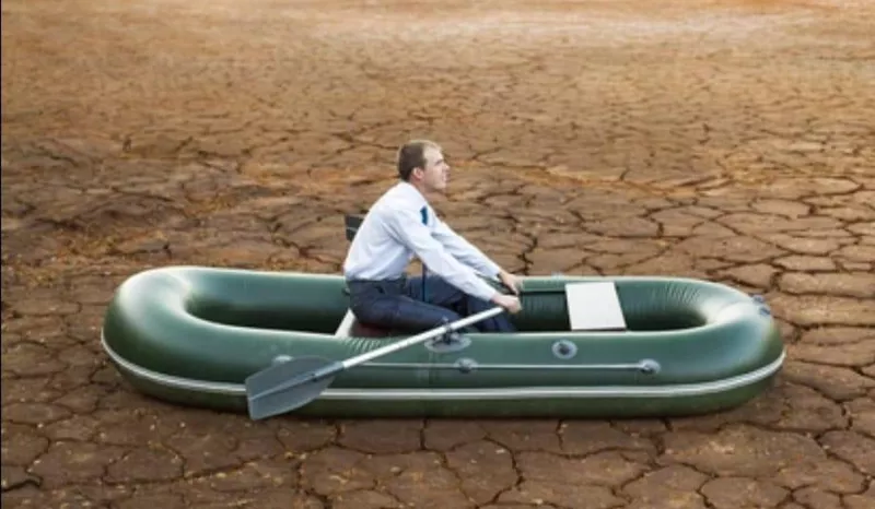 Man rowing a boat on land