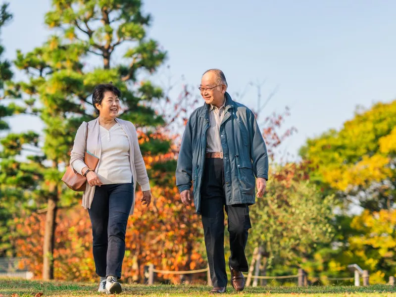 Couple enjoying walking together in public park