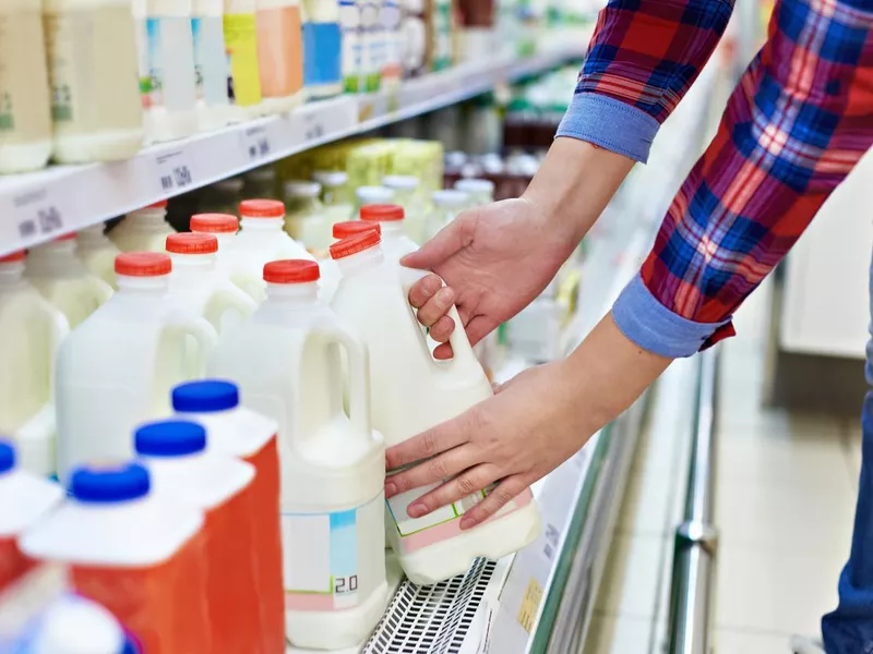 Woman shopping milk in store