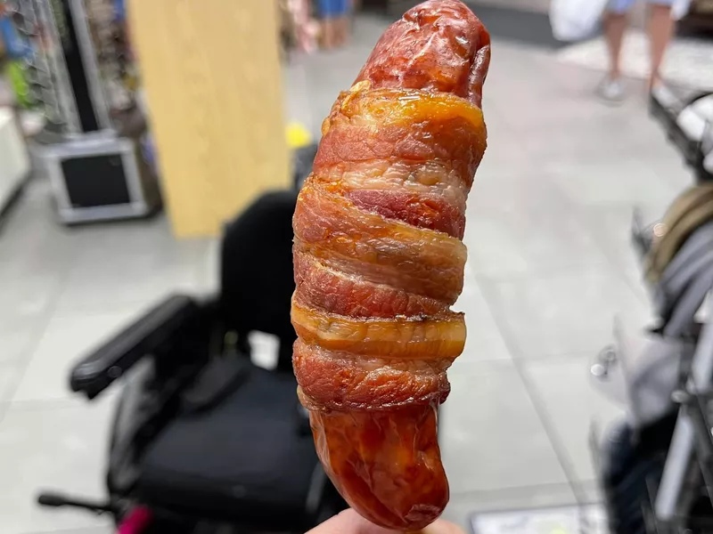 Bacon wrapped around a sausage