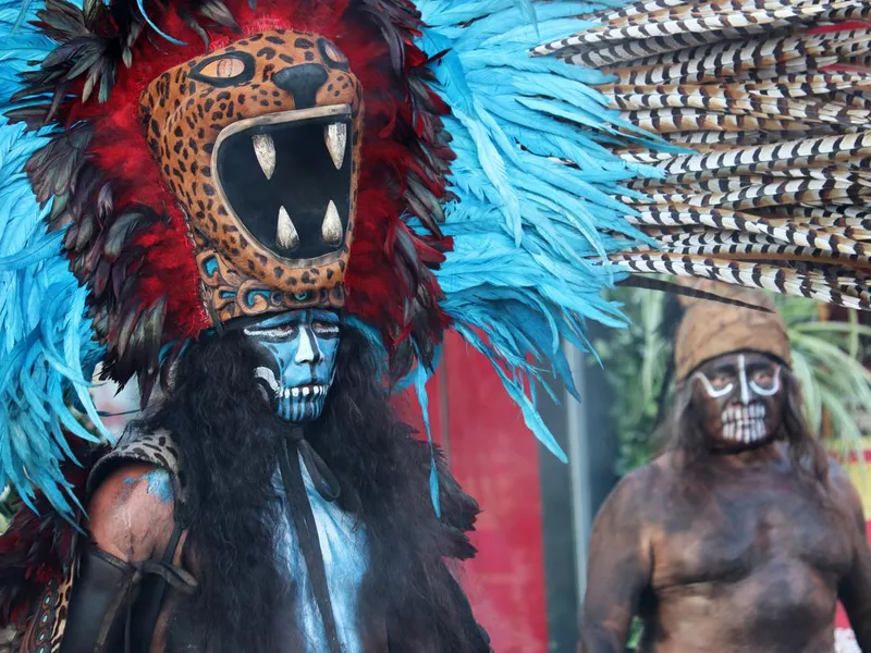 Warrior and shaman Maya in jaguar costume with feathers