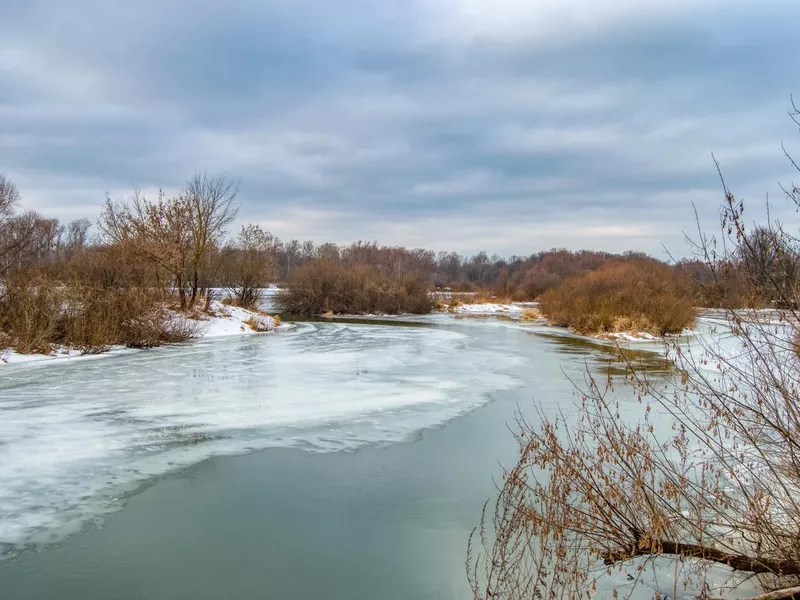 Thawing in the ice of a frozen river