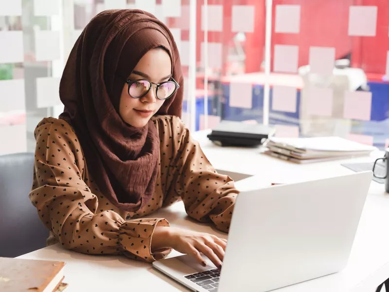 Young businesswoman working on laptop in Malaysia