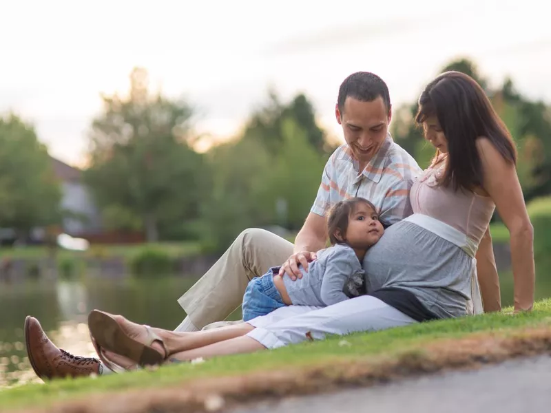 Family with their toddler and unborn