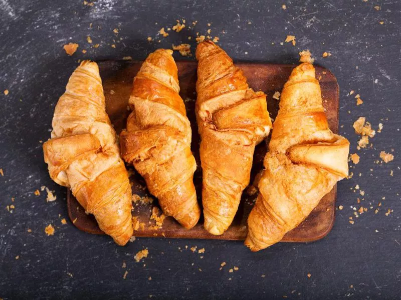 Fresh croissants on a wooden board