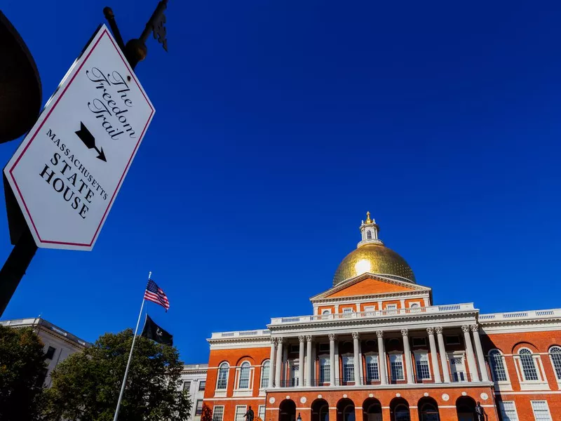 The Freedom Trail sign and the Massachusetts State House - Massachusetts Capitol - Boston Massachusetts