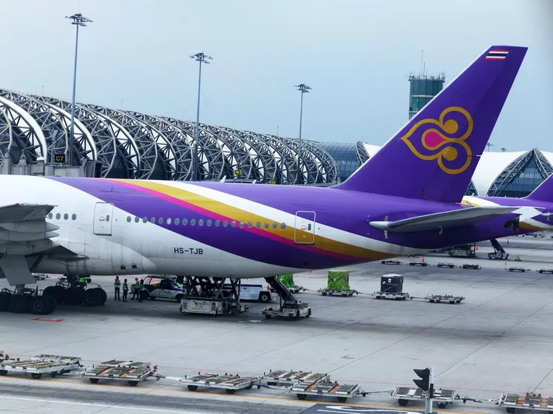 Parked Thai Airways airplanes at terminal