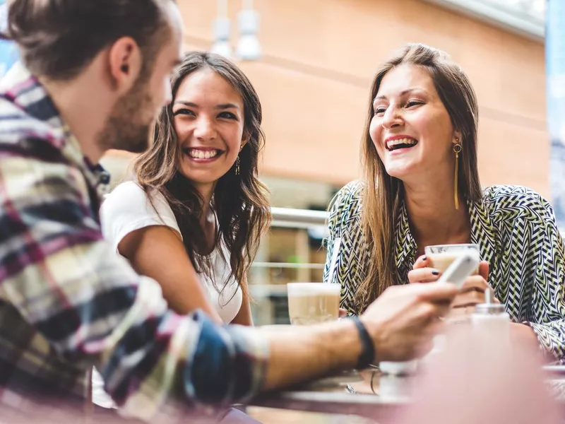 Multiracial group of friends having a coffee together