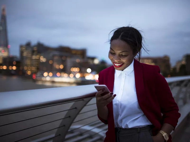 Woman using digital tablet in London