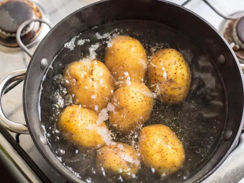 Potatoes boiling in a saucepan