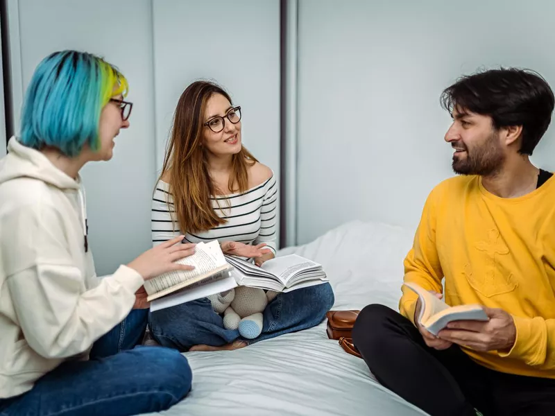 University Students discussing the Latest Book