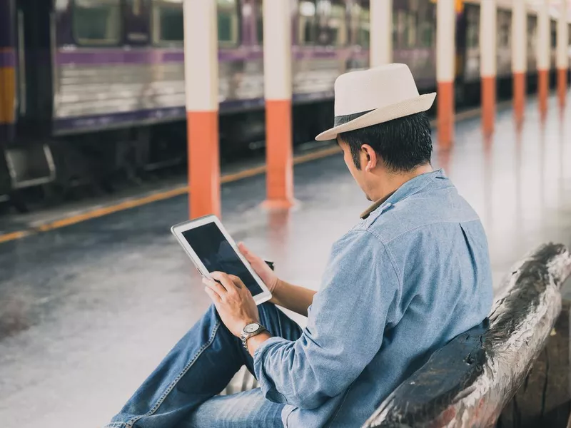 Man working at train station in Thailand